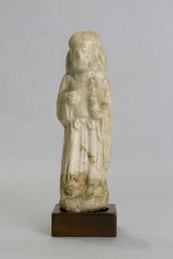 Miniature figure of an attendant carrying a vessel