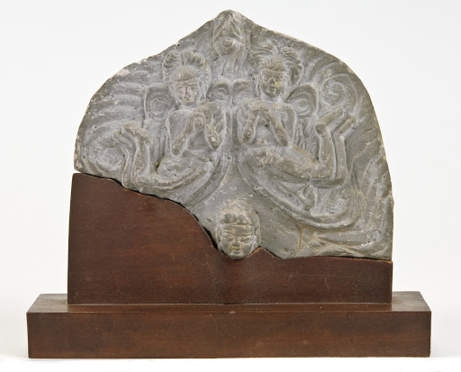 Stele fragment with head of Buddha and two asparas