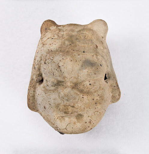 Whistle in the shape of the head of a child wearing a tiger cap