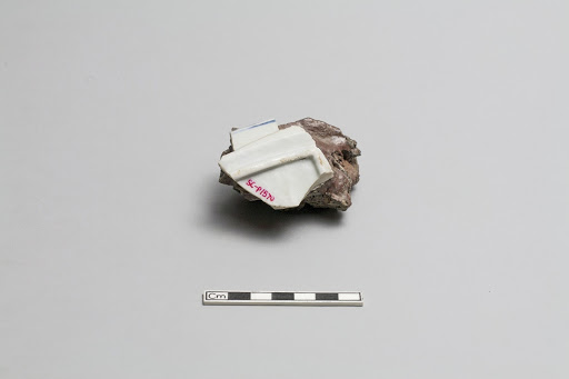 Fragment (part of foot and rim) fused to chunk of kiln debris