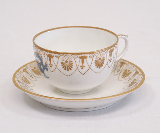 Teacup and saucer with Gion-mamori (Talisman) crest design, 
 blue and white, gold glazing, - Arita ware,Fukagawa kiln