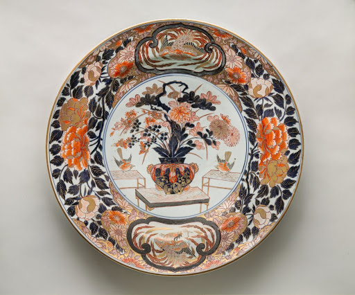 Imari-style Dish Decorated with a Vase of Flowers on a Table - Arita ware