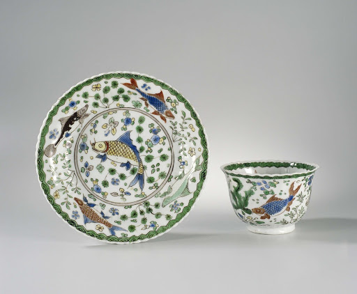 Cup and saucer with fish between water plants - Anonymous
