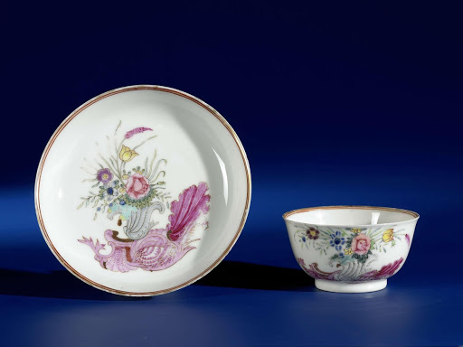 Bell-shaped cup and saucer with a snailornament and flowering plants - Anonymous