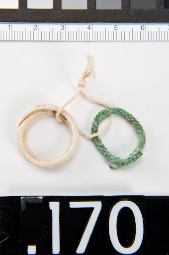 Two children's rings: a. bronze, b. glass/ceramic (?)