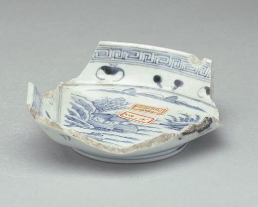 Fragment of triangular-shaped shallow bowl (including circular foot and part of sides)