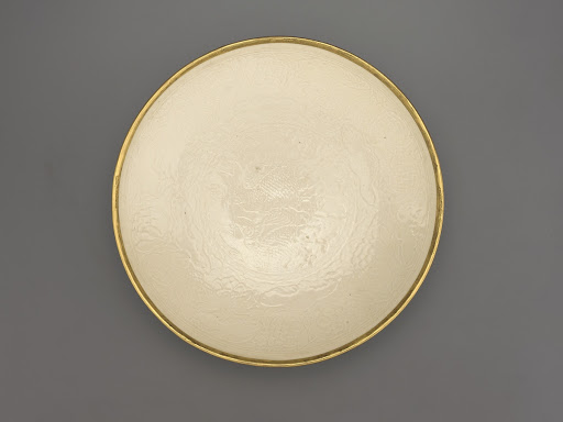 Dish with molded design of paired fish and lotus plants