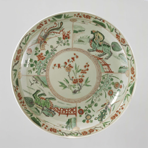 Saucer-dish with celadon glaze, prunus sprays, shishi, peacock and feng huangs - Anonymous