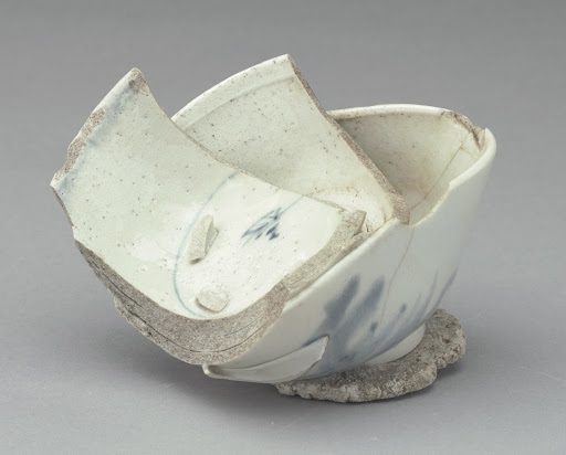 Stack of three rice bowls, fused together on wad of course white clay
