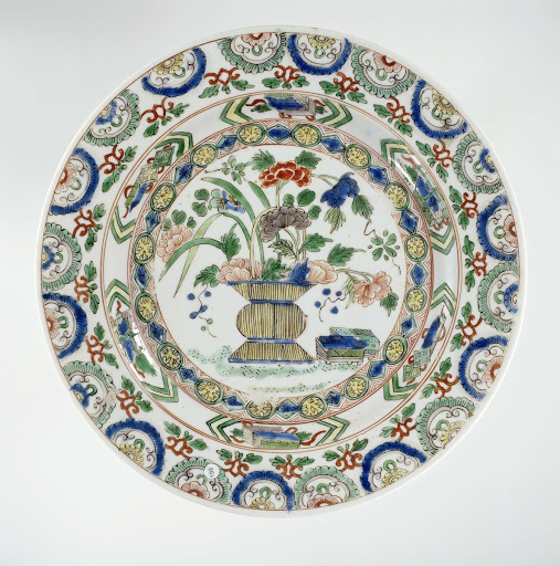 Plate with a flower basket and precious objects - Anonymous