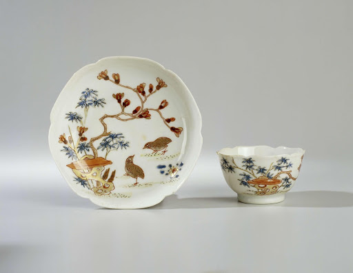 Bell-shaped cup and saucer with two quail near a rock - Anonymous