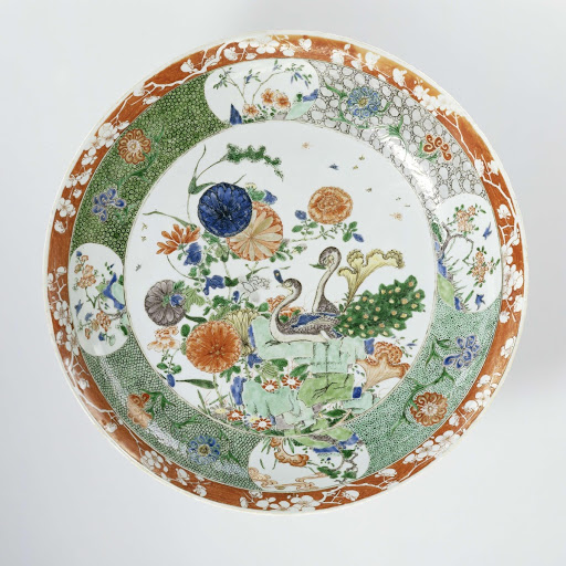 Saucer-dish with two peacocks, rocks and flowering plants - Anonymous