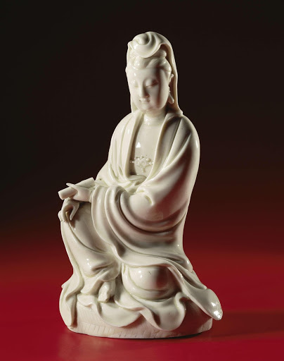 Figure of a seated Guanyin holding a scroll - Anonymous