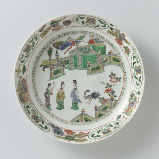 Saucer-dish with three ladies and a peacock in a fenced garden in front of a pavilion - Anonymous