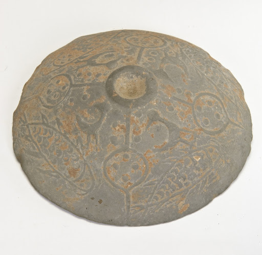 Conical disk with relief engravings