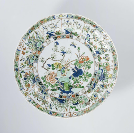 Dish with a pheasant on a rock surrounded by flowering plants - Anonymous