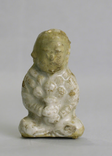 Miniature seated figure holding a vase of lotus buds