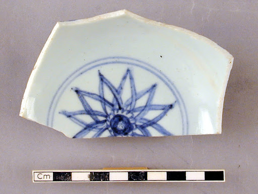 Fragment of a bowl with star-like design inside and lotus scrolls outside