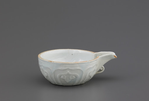 Spouted bowl with molded decoration