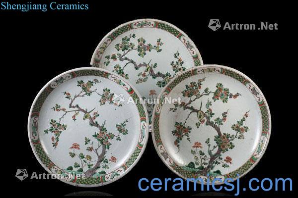 The 18th century, Three large Famille Verte dishes, each made with a central scene of birds amongst flowering trees, the cavetto with geometric motifs and auspicious Buddhist symbols (losses)