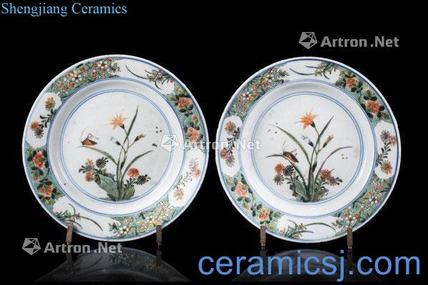 A pair of 18th century Famille Verte dishes, each with A delicate central flower with A grasshopper, the cavetto with flora decoration