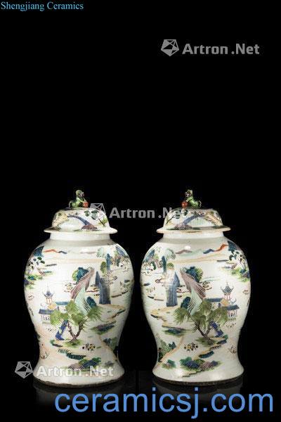 In the 18th century A pair of large Famille Verte baluster jars and covers, each decorated with A continuous landscape scene with rivers, figures in pavilions and mountains, the covers surmounted by Buddhist lions