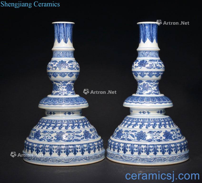 The QING DYNASTY A PAIR OF BLUE AND WHITE CANDLESTICKS