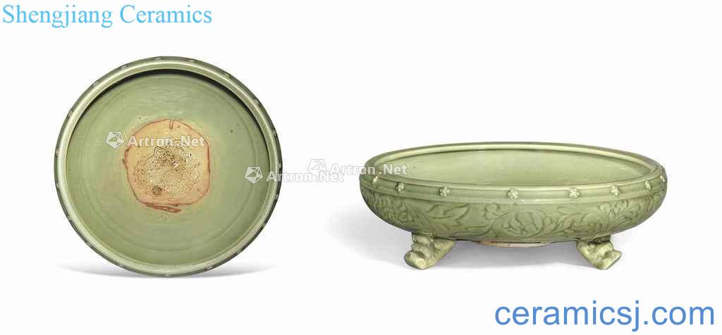 In the Ming dynasty, 14 to 15 century A CARVED LONQUAN CELADON TRIPOD CENSER