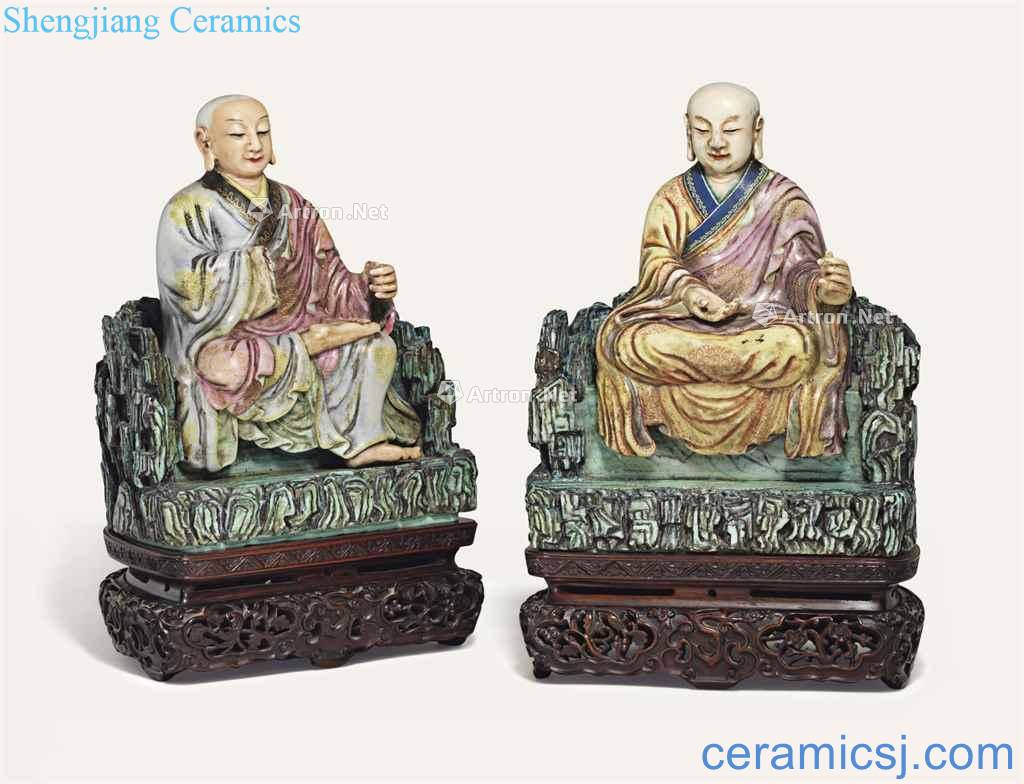 In the 18th century TWO FAMILLE ROSE SEATED FIGURES OF LUOHAN