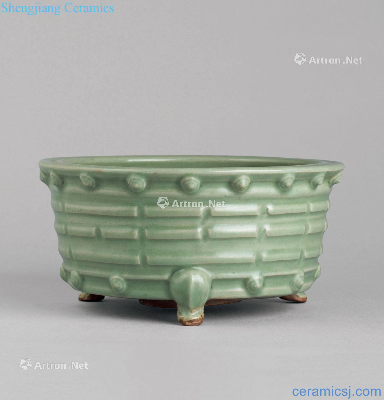 In the Ming dynasty Longquan celadon gossip drum nail grain three-legged censer