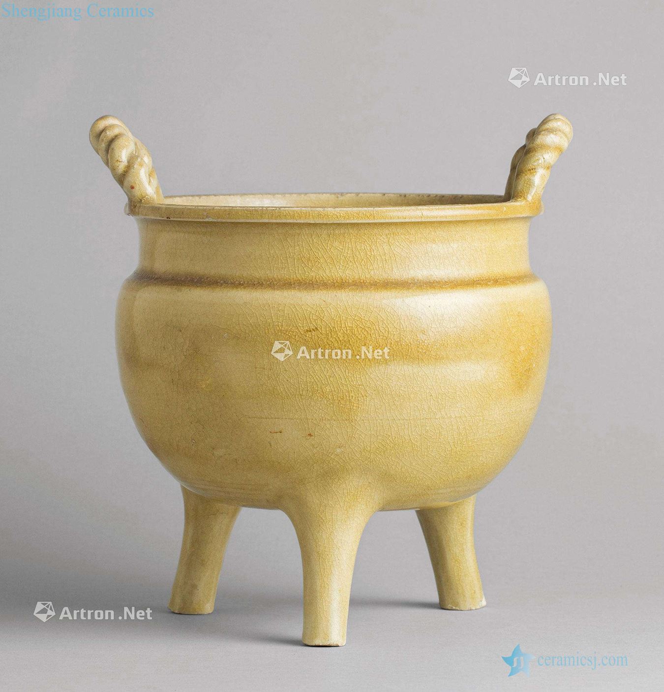 In the Ming dynasty (1368-1644), cream-colored glaze double rope ear three-legged censer