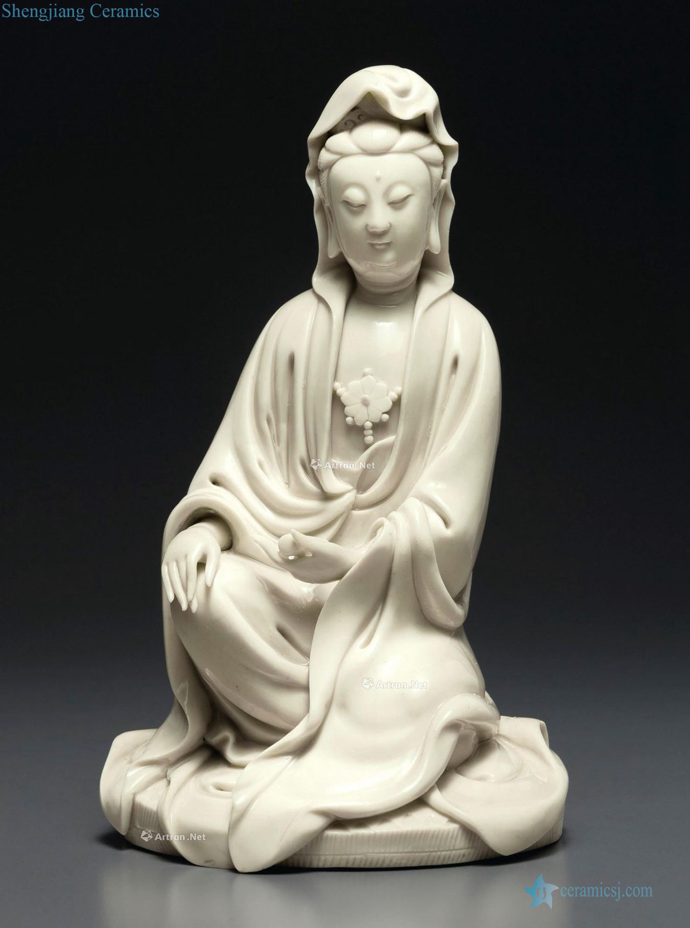 In the Ming dynasty, early 17th century A DEHUA FIGURE OF GUANYIN WITH A SCROLL