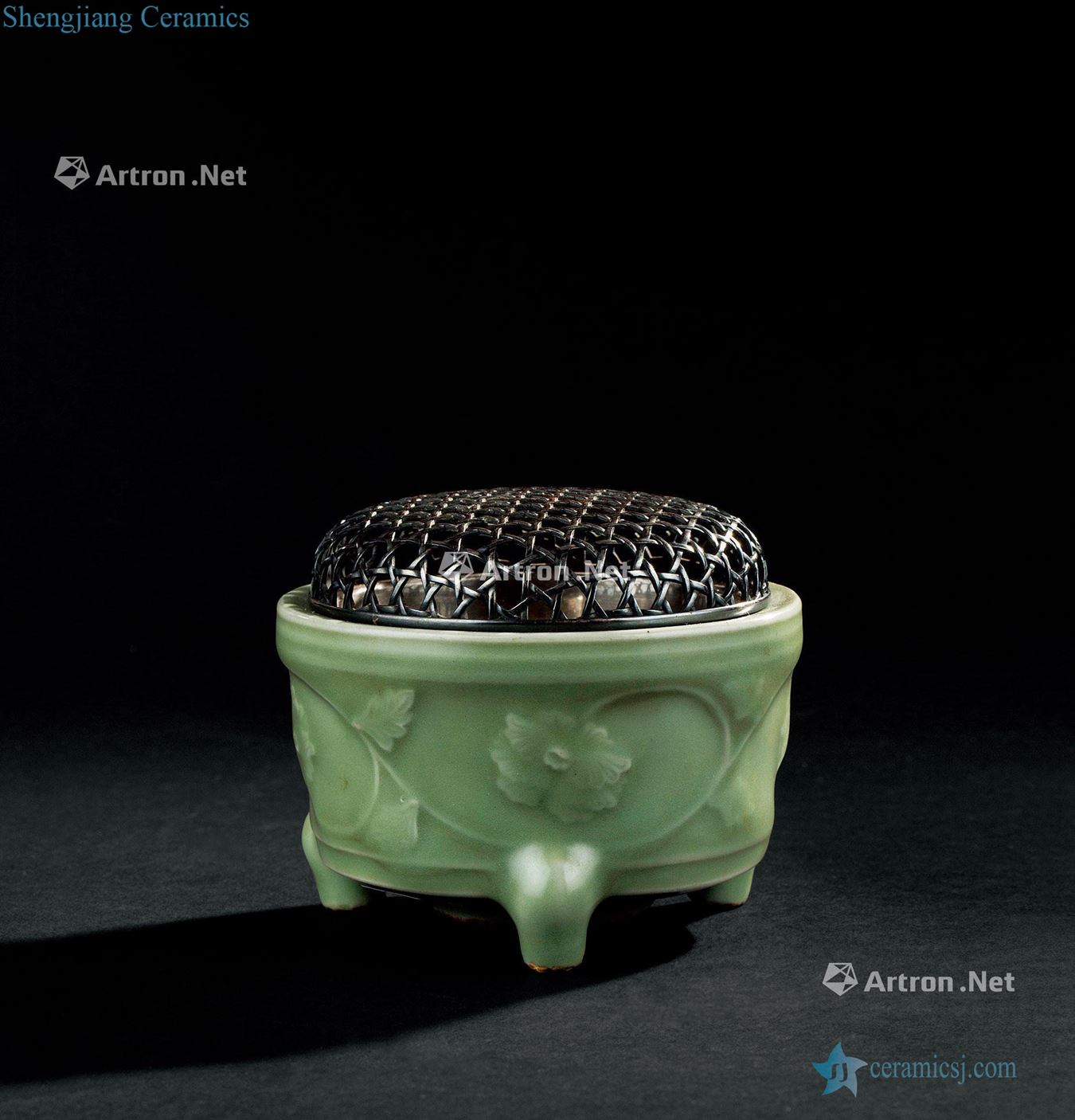 In the Ming dynasty (1368-1644), longquan celadon branch flowers lines three-legged censer