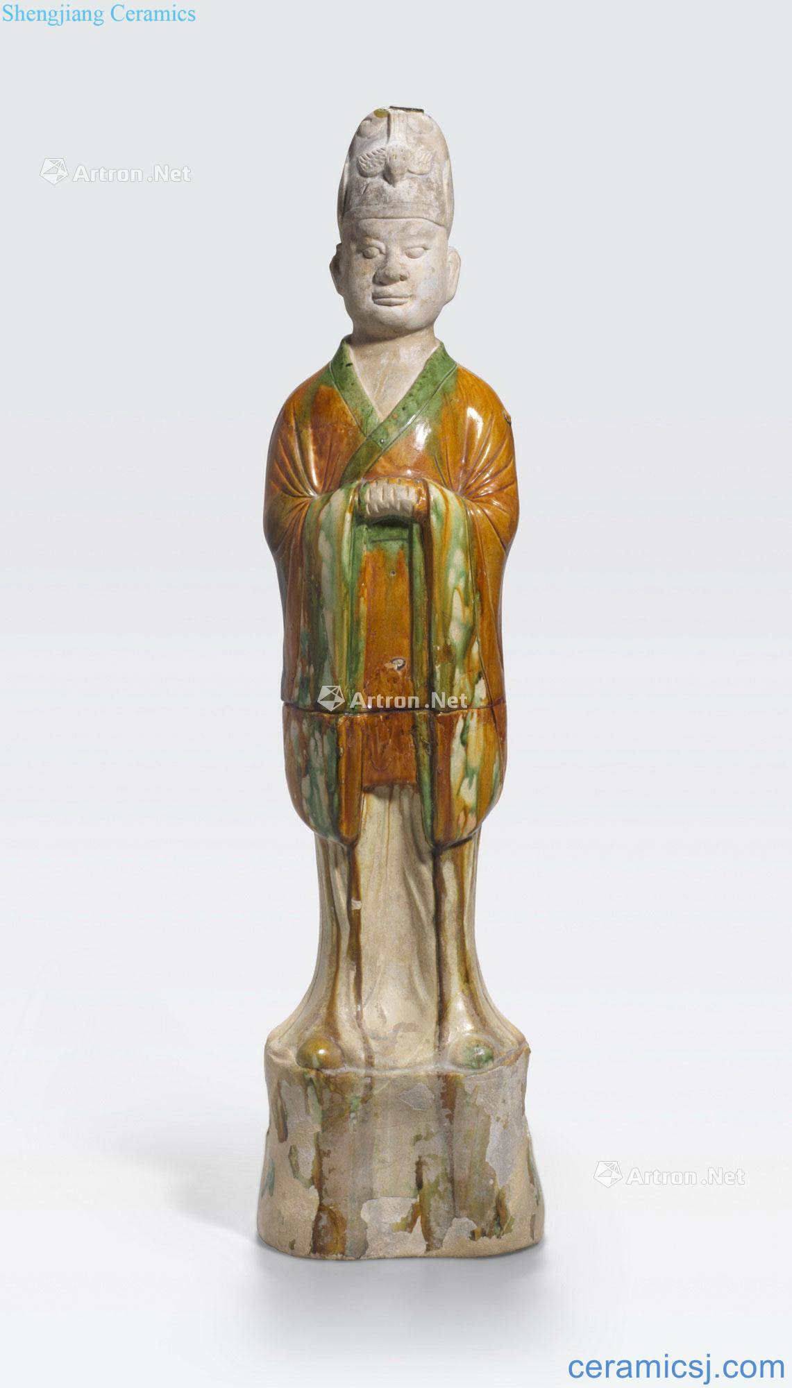 Tang dynasty A SANCAI GLAZED FIGURE OF A STANDING OFFICIAL